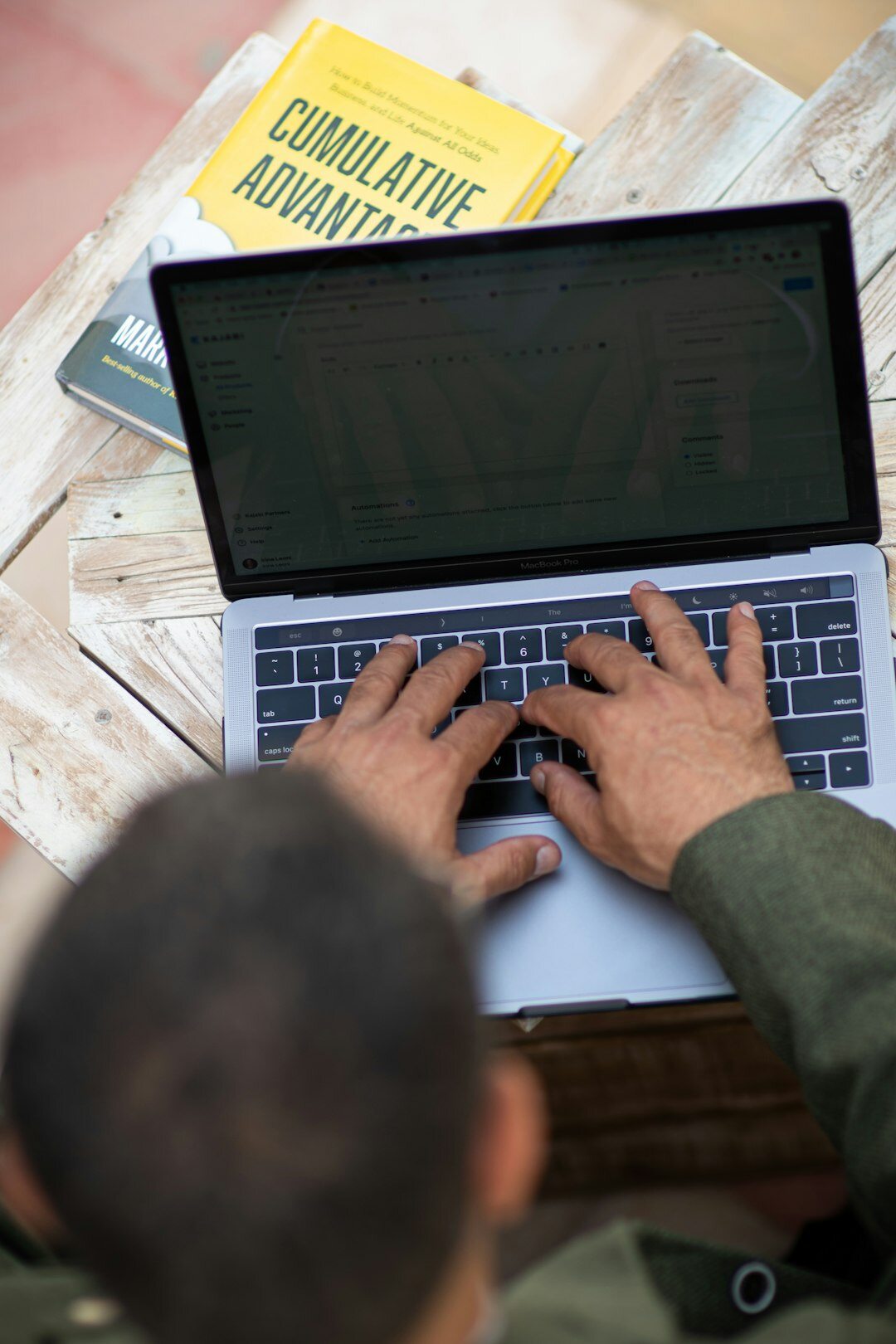 author typing on laptop